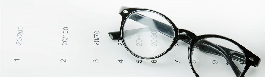 Eyeglasses Resting On Vision Chart