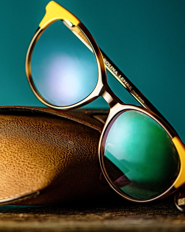Eyeglasses Resting On Case With Reflective Lenses
